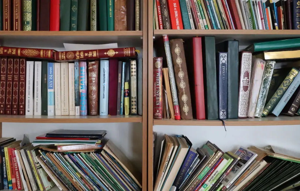 Colorful bookshelf with a variety of books including religious texts and educational materials.