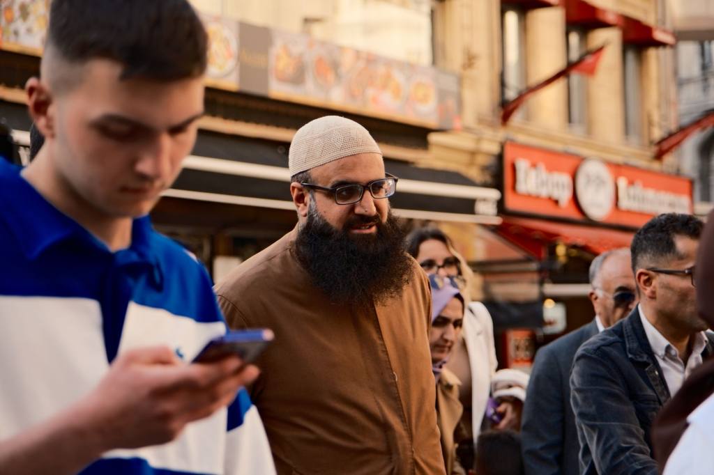 People walking through a busy street in Istanbul, showcasing urban culture and diversity.